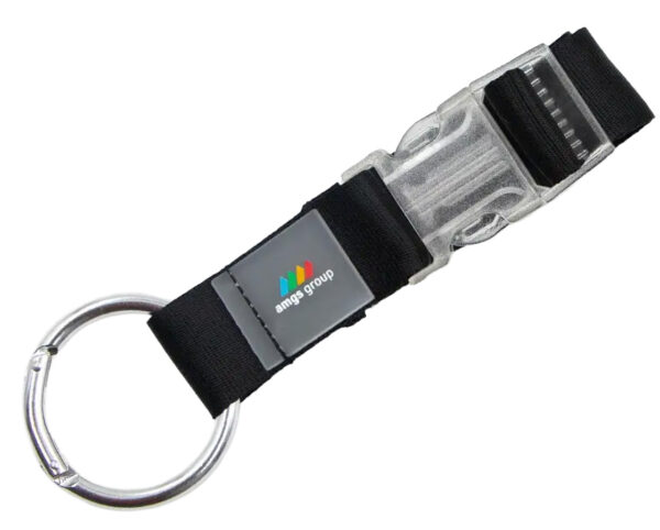 Gancio porta giacca nero con fibbia trasparente e anello metallico, ideale per eventi e fiere. Disponibile presso il tuo partner esperto in soluzioni promozionali.